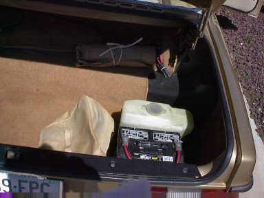 The battery and washer tank are mounted in the trunk